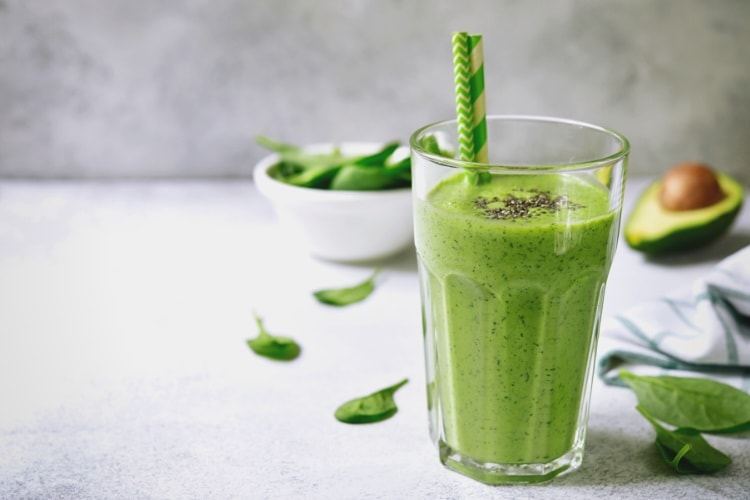 Green smoothie with avocado seed and spinach