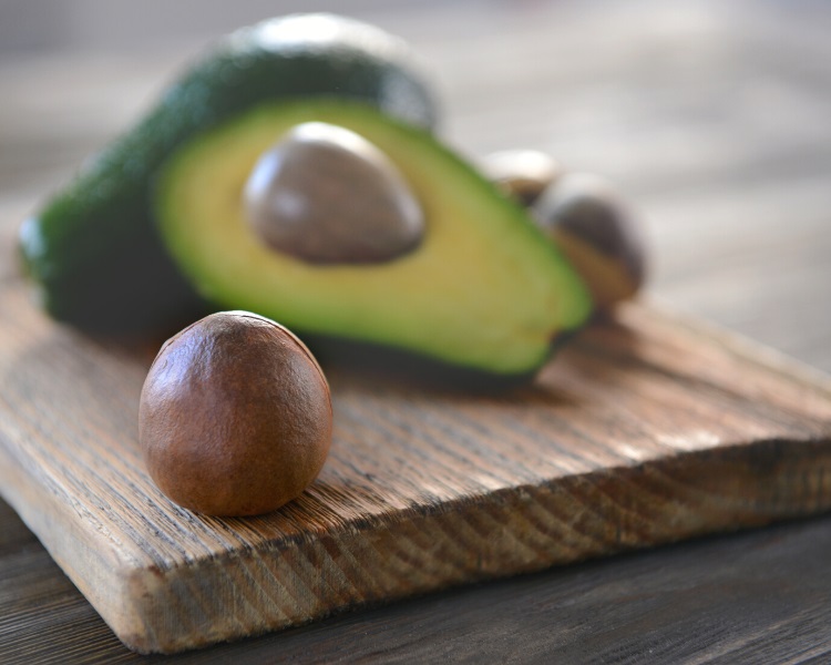 Avocado seed on cutting board