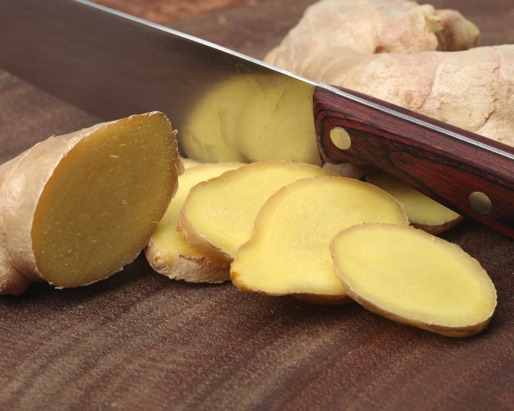 Cutting ginger with knife