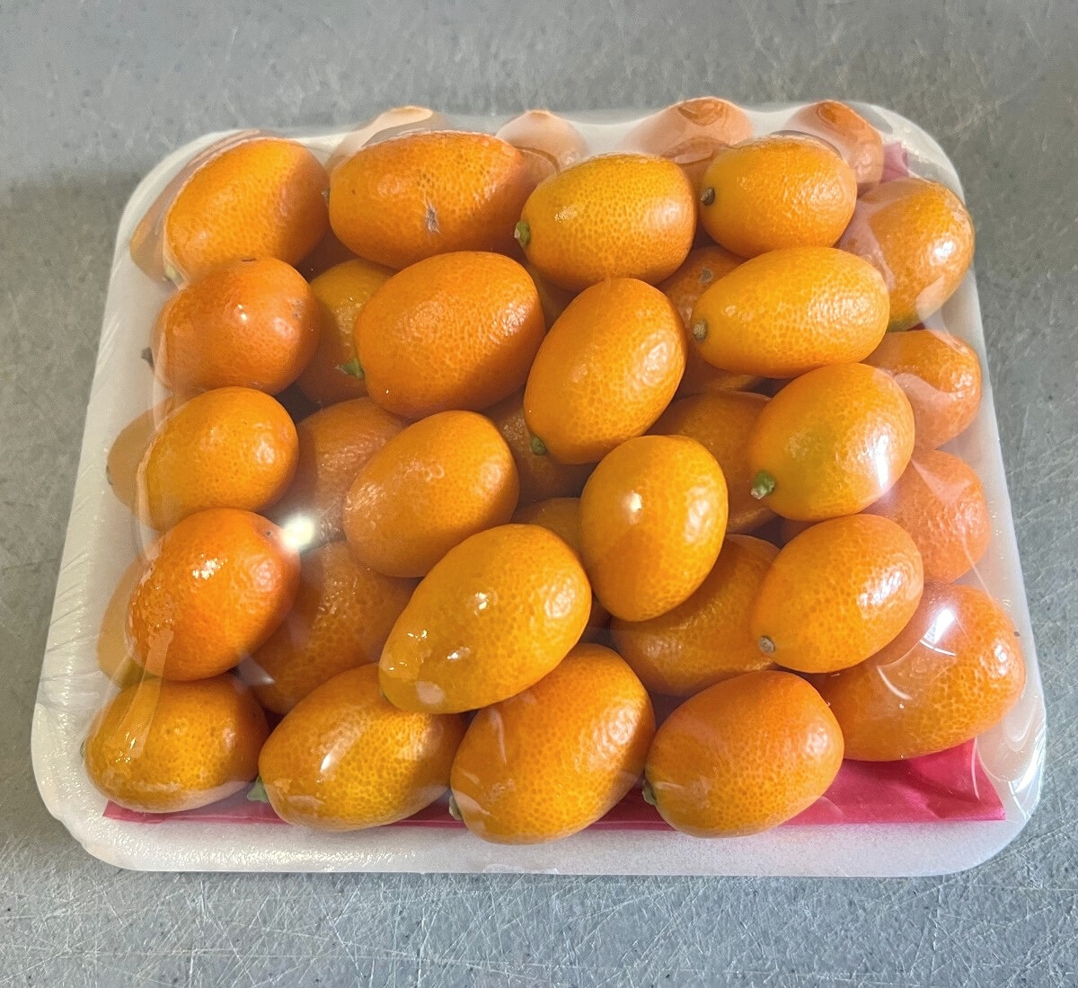 Fresh kumquats in tray