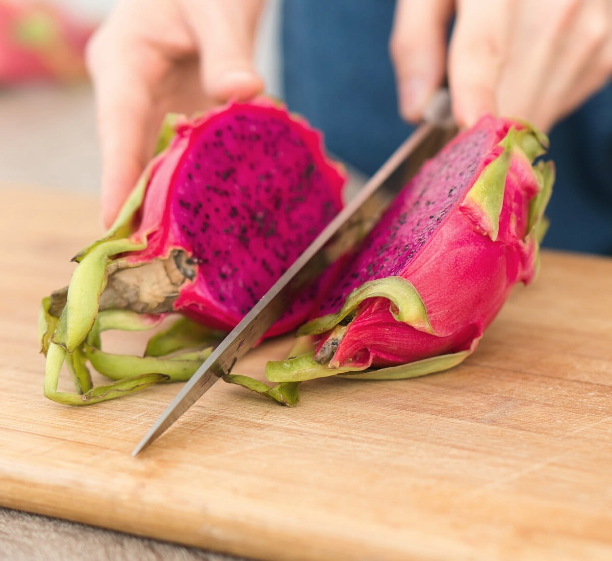 Cutting dragon fruit lengthwise